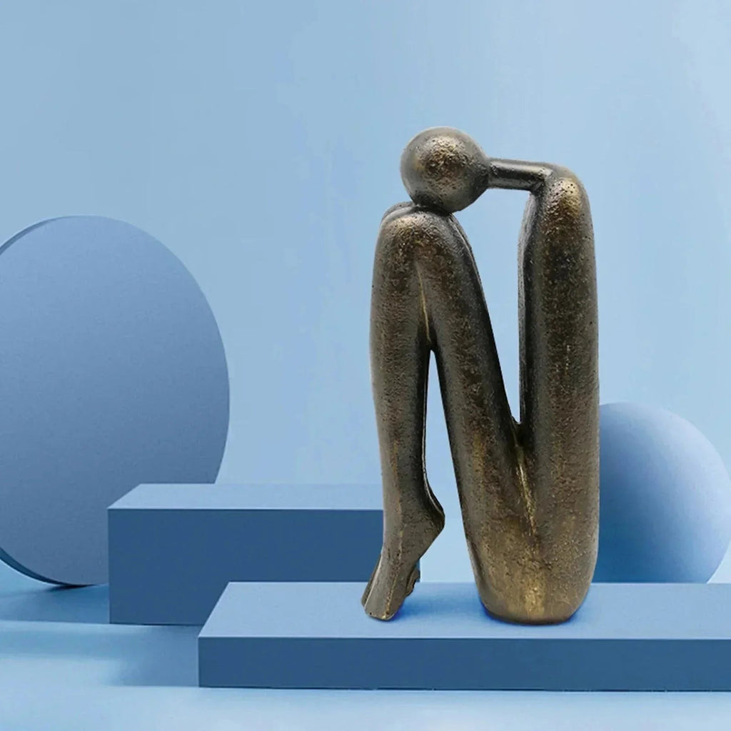 Buchstütze aus Kunstharz, beschwerte Figur in skulpturaler Form